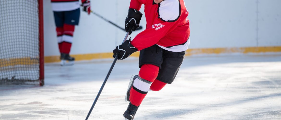 Professional ice hockey player in attack on the rink.