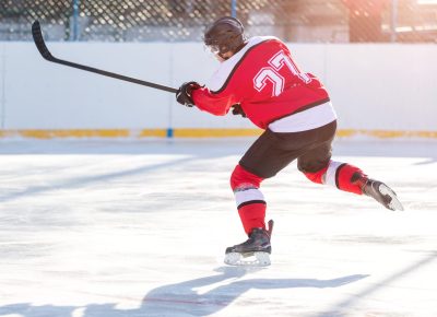 Professional ice hockey player in attack on the rink.